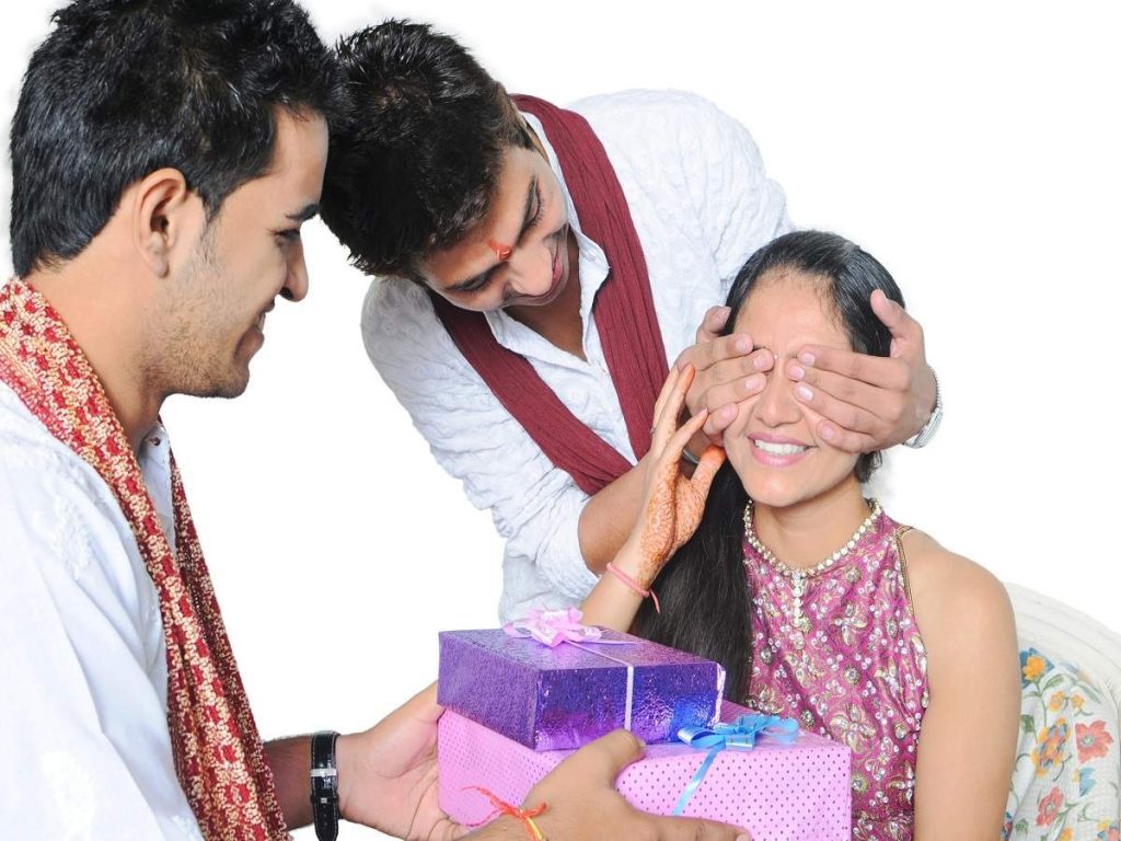 brothers giving gift to her sister for Raksha Bandhan