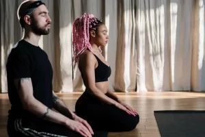 man and women doing yoga