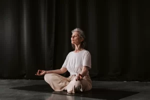 old women doing deep breathing yoga